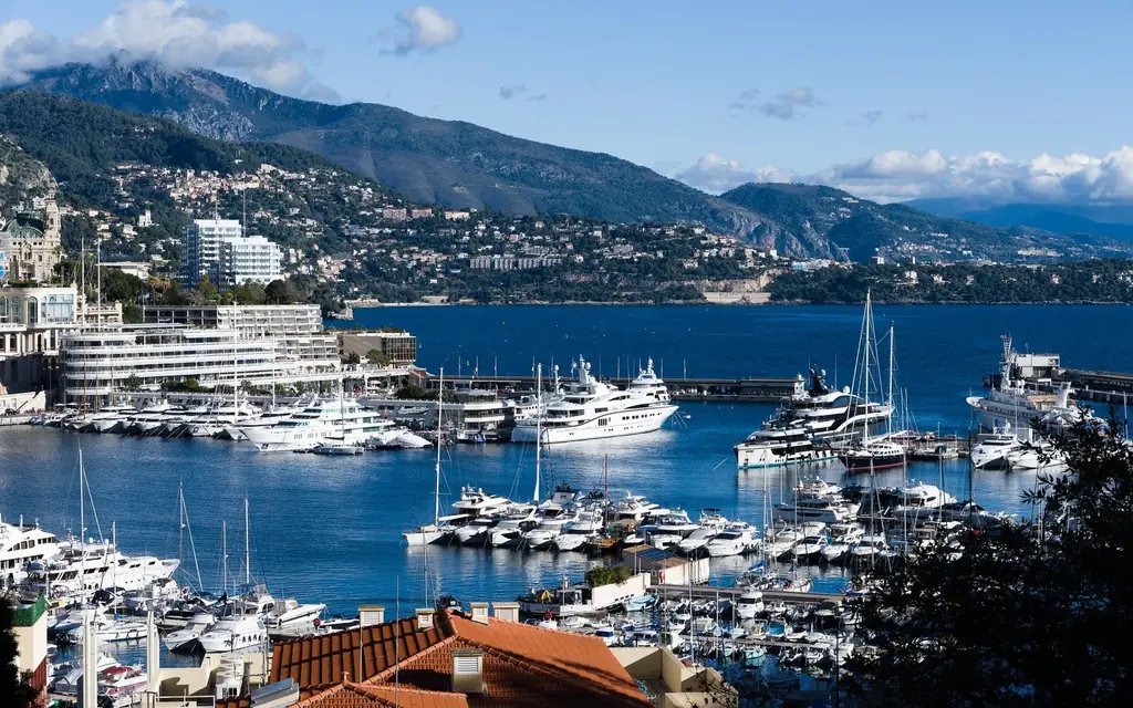 Breathtaking view of Monaco marina with luxurious yachts and scenic backdrop