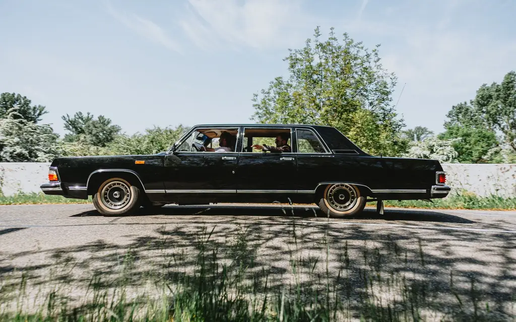 Black stretch limousine parked on a sunny street