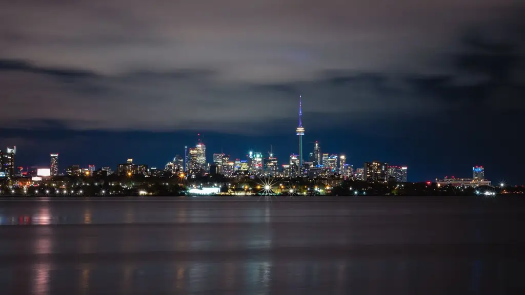 Stunning view of Toronto's skyline with the illuminated CN Tower across the lake at night