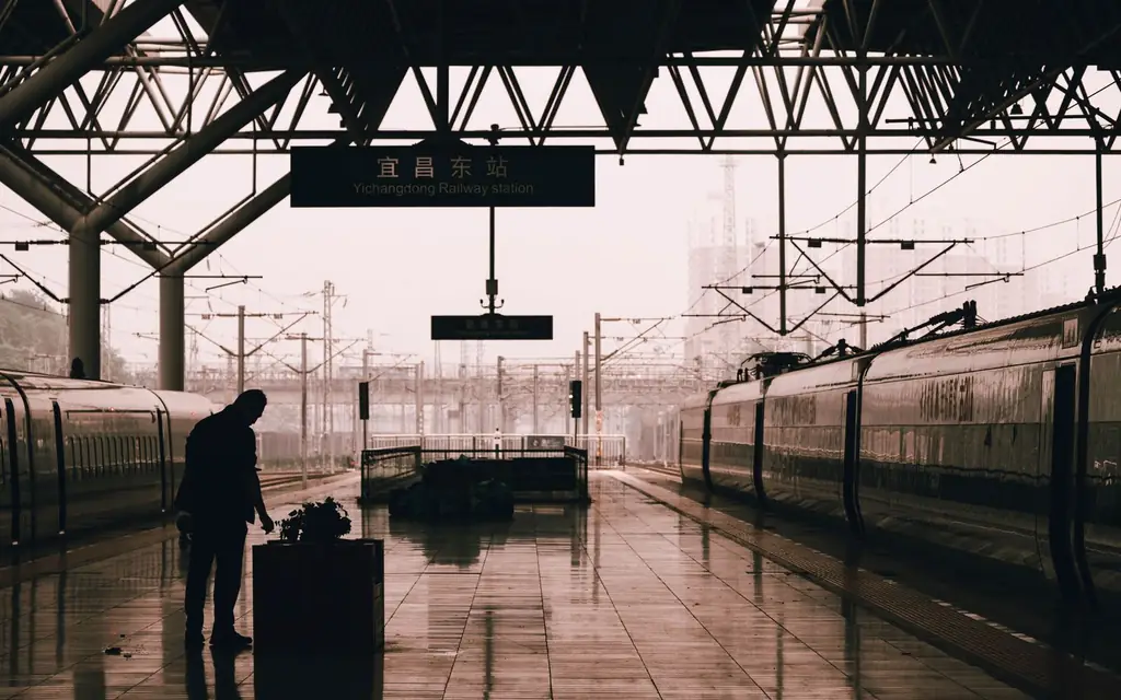 Passenger on a station platform beside a train
